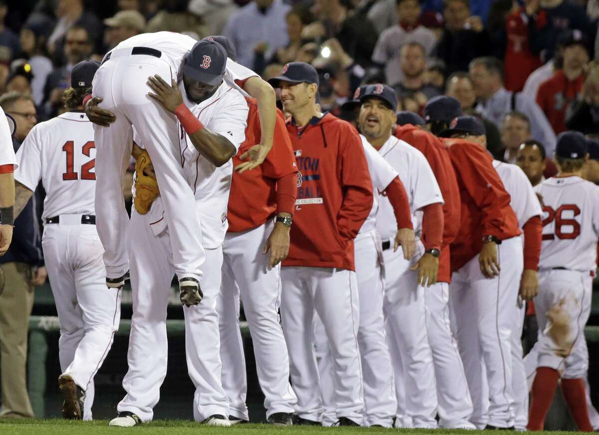 Boston Red Sox designated hitter David Ortiz, left, picks up relief pitcher Koji Uehara to celebrate their 8-7 victory over the Washington Nationals.