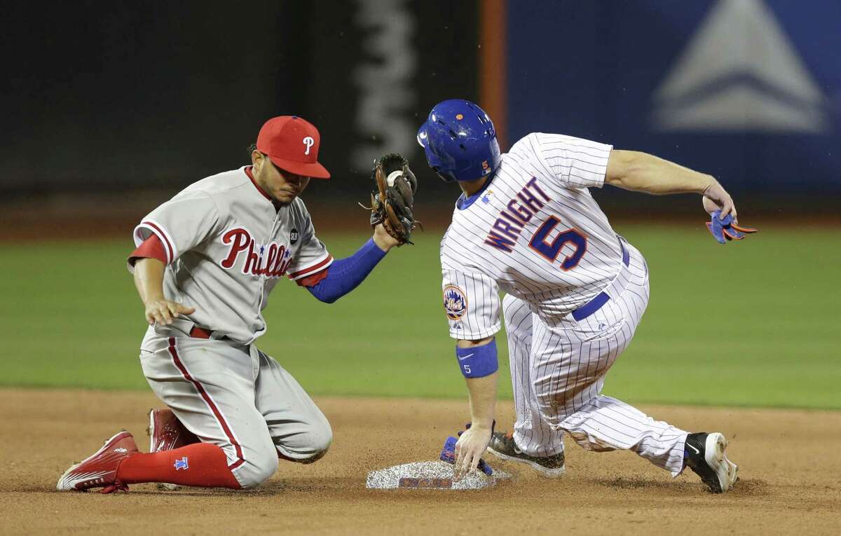 Philadelphia Phillies shortstop Freddy Galvis (13) has the ball but the Mets’ David Wright is safe on an eighth-inning stolen base. Wright left the game with a pulled right hamstring.