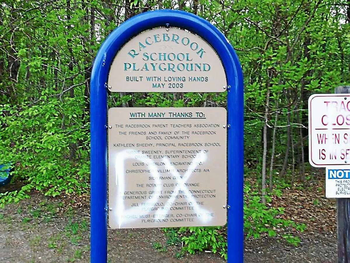 Police in Orange are investigating after someone spray-painted “DX” and male genitalia on a school building, walking track and playground equipment at Race Brook School.