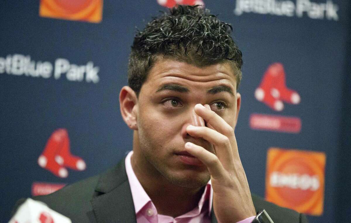 Boston Red Sox infielder Yoan Moncada wipes away tears as he speaks about his agent, David Hastings, during a press conference Friday in Fort Myers Fla.