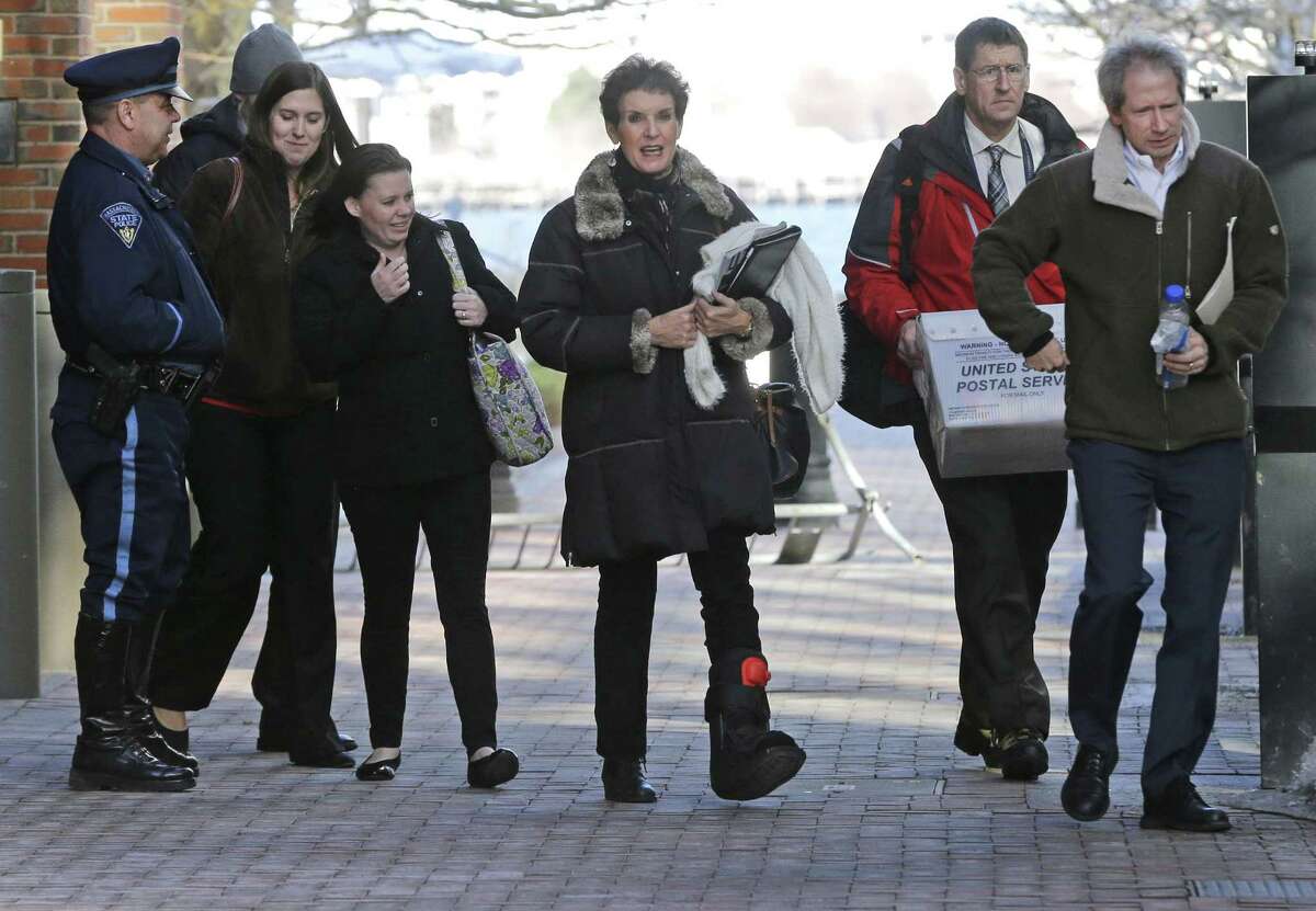 People leave federal court to board a bus carrying Boston Marathon bombing survivors, family and friends after attending the federal death penalty trial of Dzhokhar Tsarnaev in Boston, Thursday, March 12, 2015. Tsarnaev is charged with conspiring with his brother to place two bombs near the Boston Marathon finish line that killed three and injured more than 260 people in April 2013. (AP Photo/Elise Amendola)
