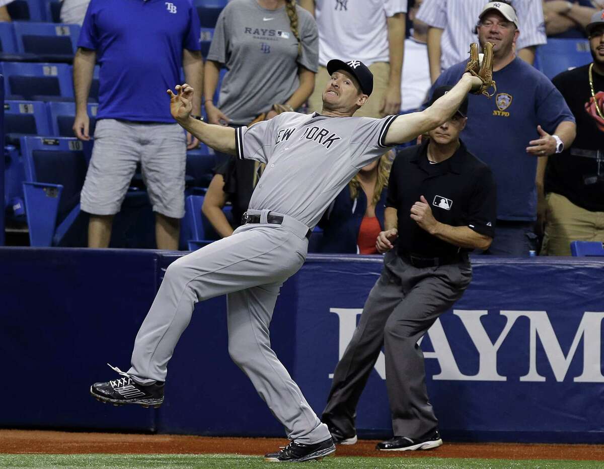 Yankees third baseman Chase Headley makes an off-balance catch on a foul pop by Rene Rivera during the eighth inning on Thursday.