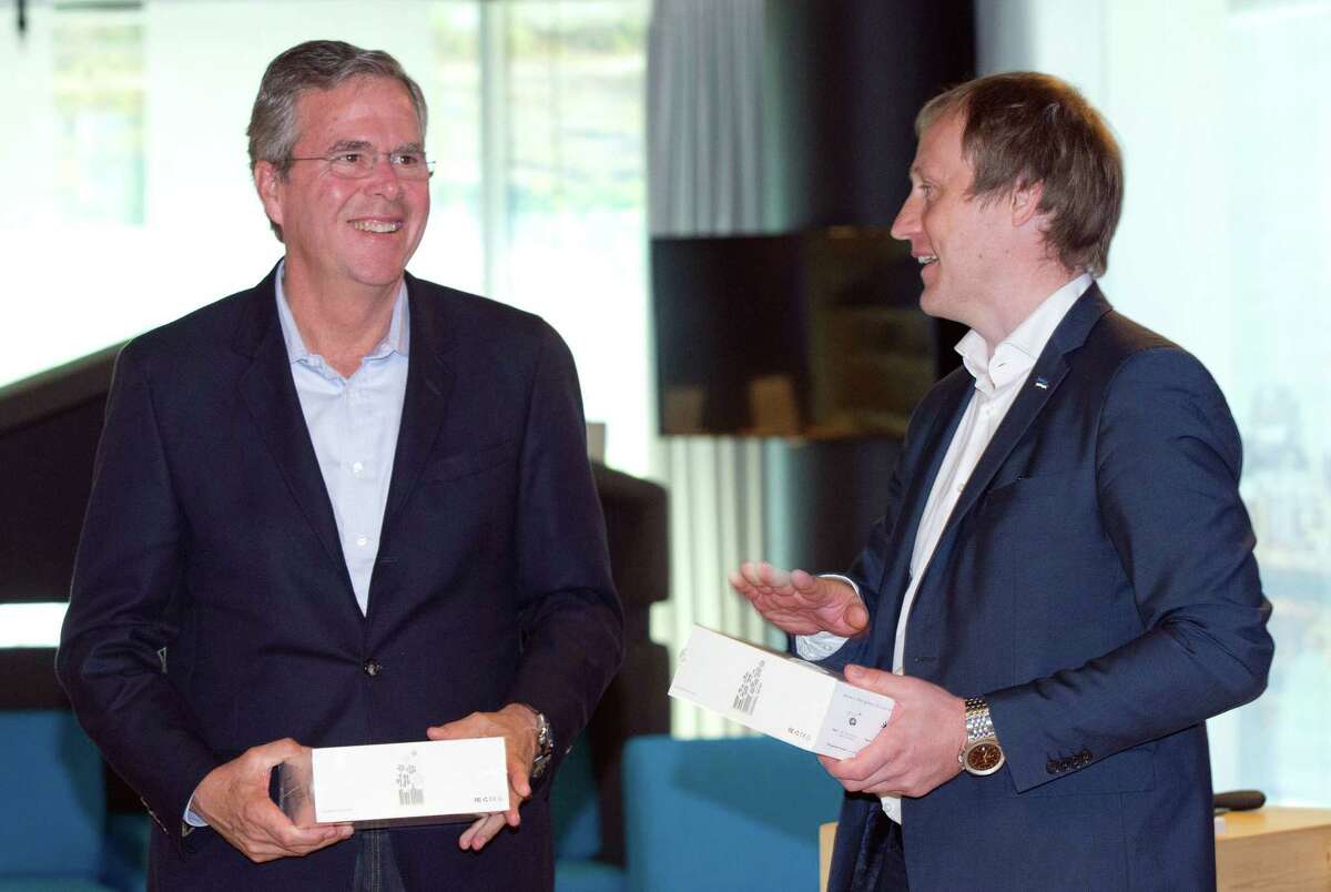 Former Florida Gov. Jeb Bush, left, smiles while listening to Taavi Kotka, Deputy Secretary General - ICT at Ministry of Economic Affairs and Communications for Estonia at the e- Estonia Showroom during his visit in Tallinn, Estonia on June 13, 2015.