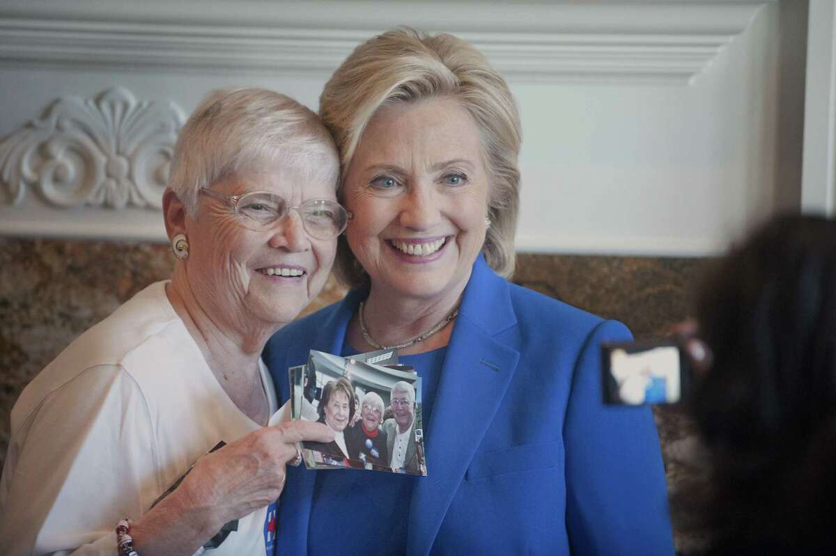 Anita Wendt, of Sioux City, Iowa poses for a photo with Democratic presidential hopeful, former Secretary of State Hillary Rodham Clinton, during a campaign house party on June 13, 2015, in Sioux City, Iowa.