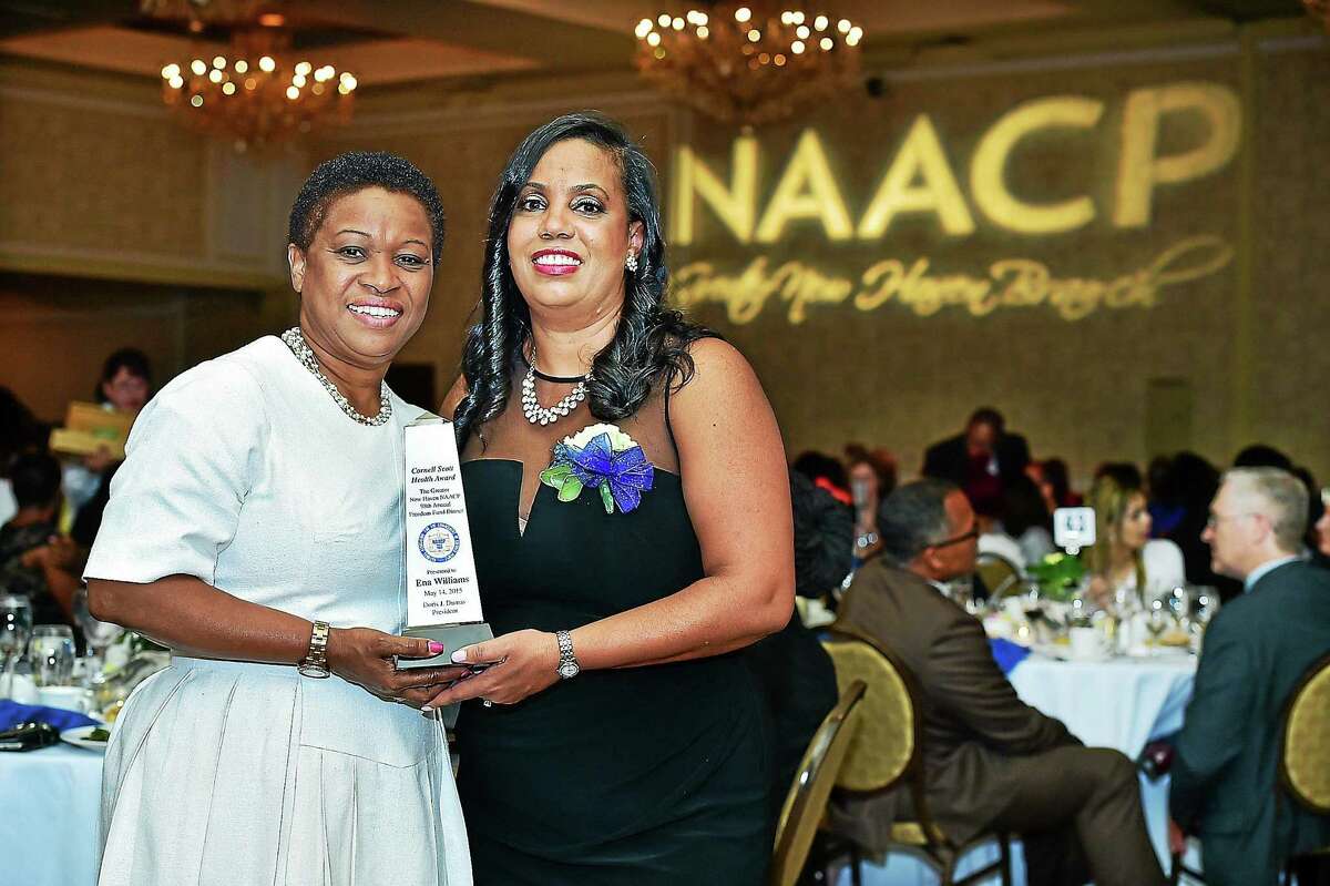 Doris J. Dumas, President of the New Haven NAACP, at right, presents the Cornell Scott Health Award to Ena Williams, Thursday, May 14, 2015, at the 98th annual Freedom Fund Dinner, at the Omni at Yale. Williams, a registered nurse, emigrated to the U.S. from Jamaica in 1992 and currently serves as the Vice President/Associate Chief Nursing Officer for Patient Services at Yale New Haven Hospital.