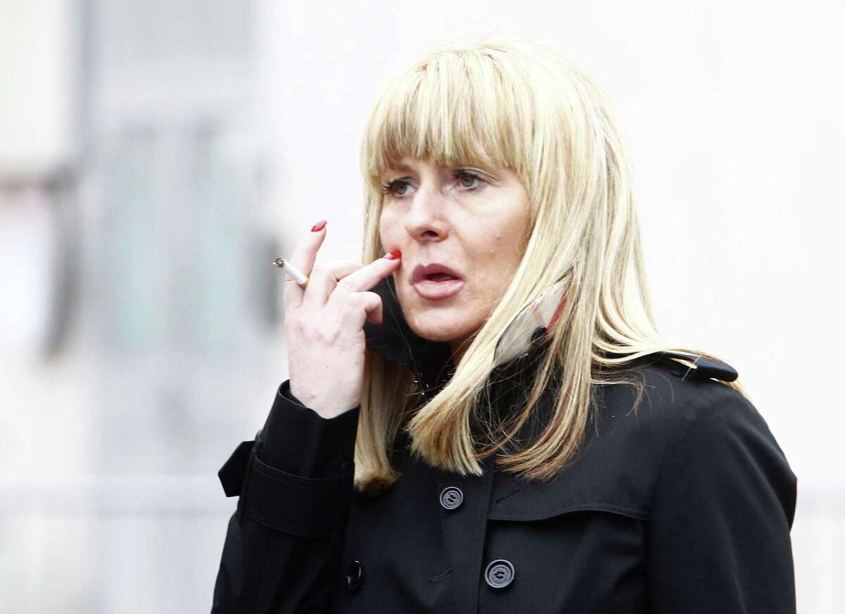 Beatrice Legrain leaves the Lille courthouse, northern France, Tuesday, Feb. 10, 2015. Dominique Strauss-Kahn goes on trial for sex charges in France. The former head of the International Monetary Fund, whose career went down in flames amid accusations of sexually assaulting a hotel maid in New York, is facing similarly shocking charges in France: aggravated pimping and involvement in a prostitution ring operating out of luxury hotels.(AP Photo/Michel Spingler)