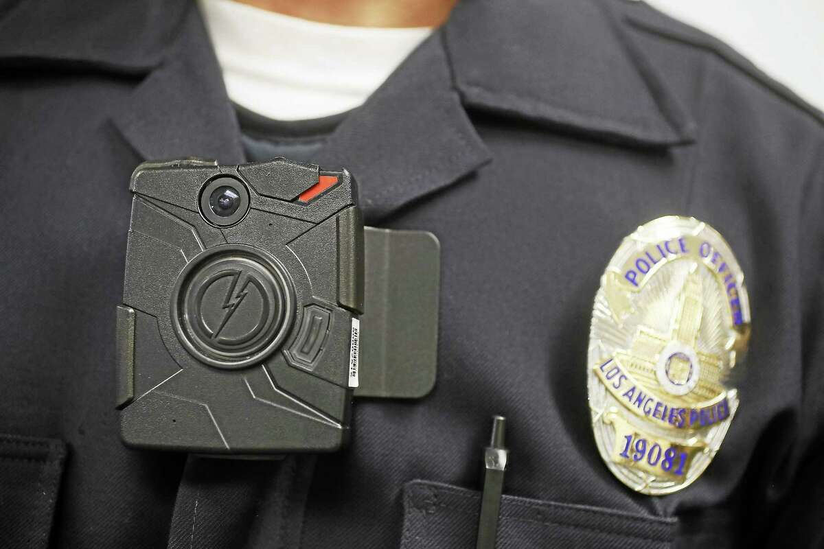 In this Jan. 15, 2014, file photo, a Los Angeles Police officer wears an on-body camera during a demonstration for media in Los Angeles.