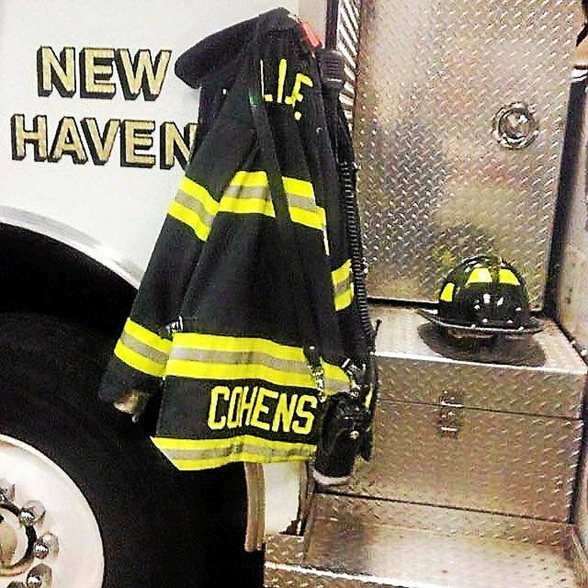 The EMS duty jacket, radio and helmet belonging to paramedic Linda Cohens hangs from a New Haven Fire Department truck Monday, a day after Cohens was found dead outside her home in Hamden. Police are still investigating her death.