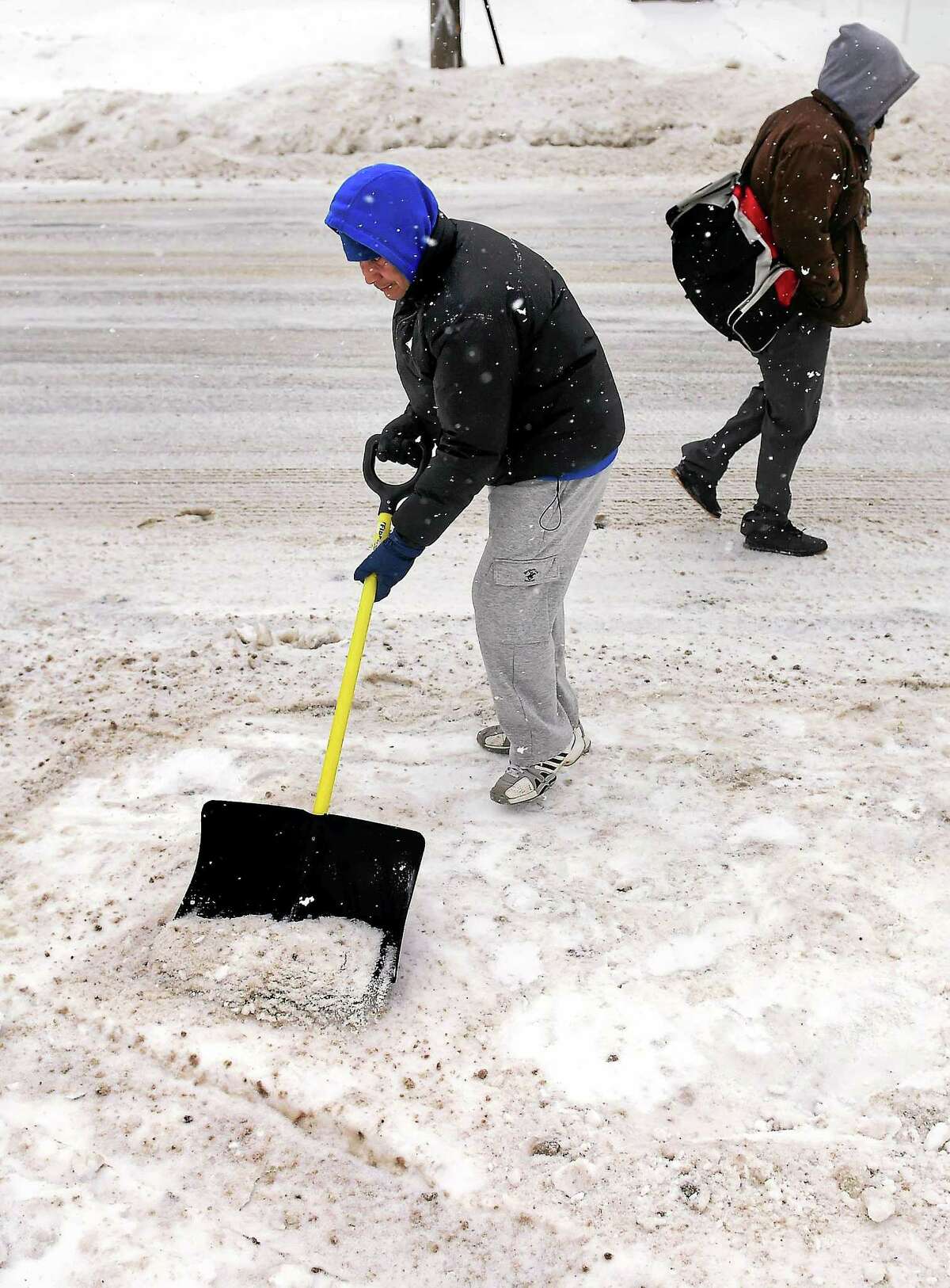 Victor Erazo shovels snow and ice in front of his home on Wakelee Ave. in Ansonia on 2/9/2015.