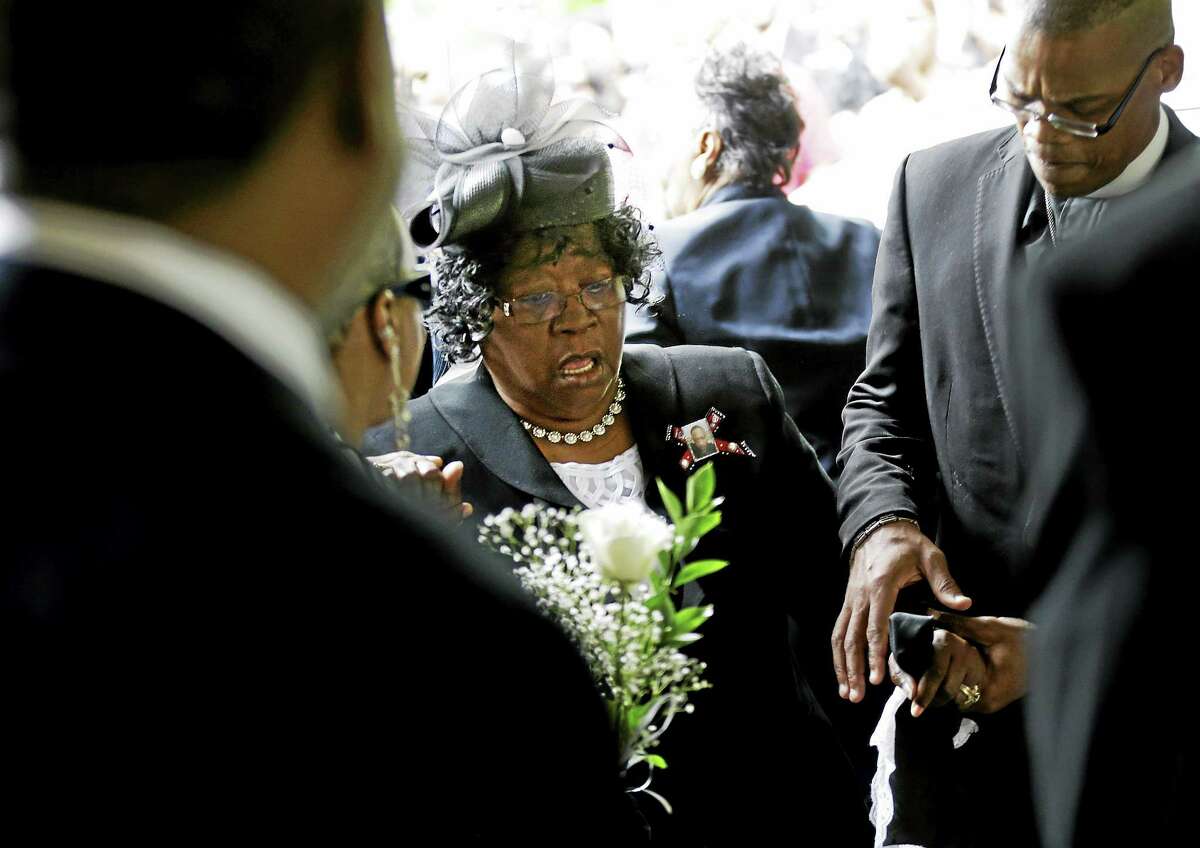 Judy Scott is escorted in for the funeral of her son, Walter Scott, at W.O.R.D. Ministries Christian Center, Saturday, April 11, 2015, in Summerville, S.C. Scott was killed by a North Charleston police officer after a traffic Saturday, April 4, 2015. The officer, Michael Thomas Slager, has been charged with murder.