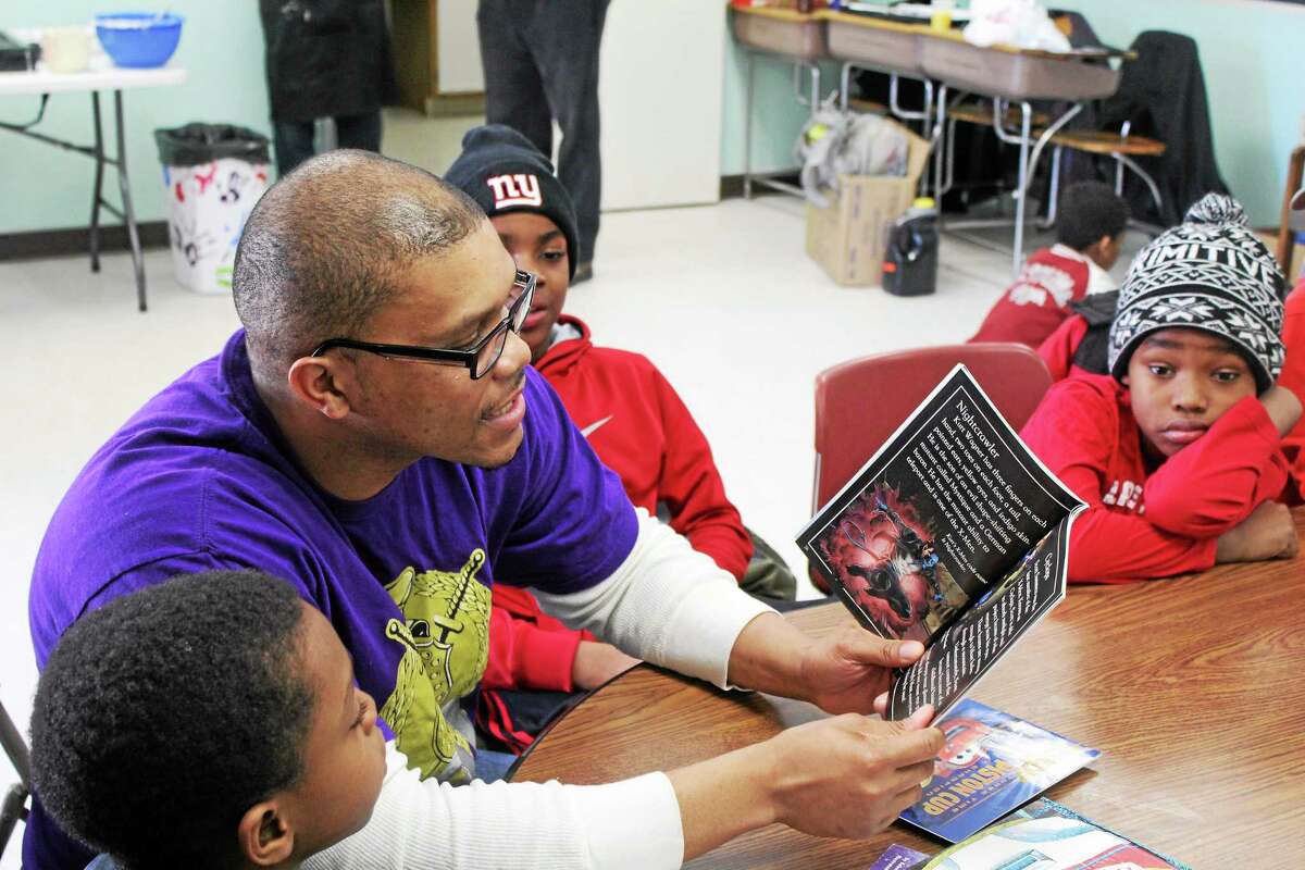 Chapter member Antonio Jefferson takes part in the reading program to youth at 730 George St. in New Haven.
