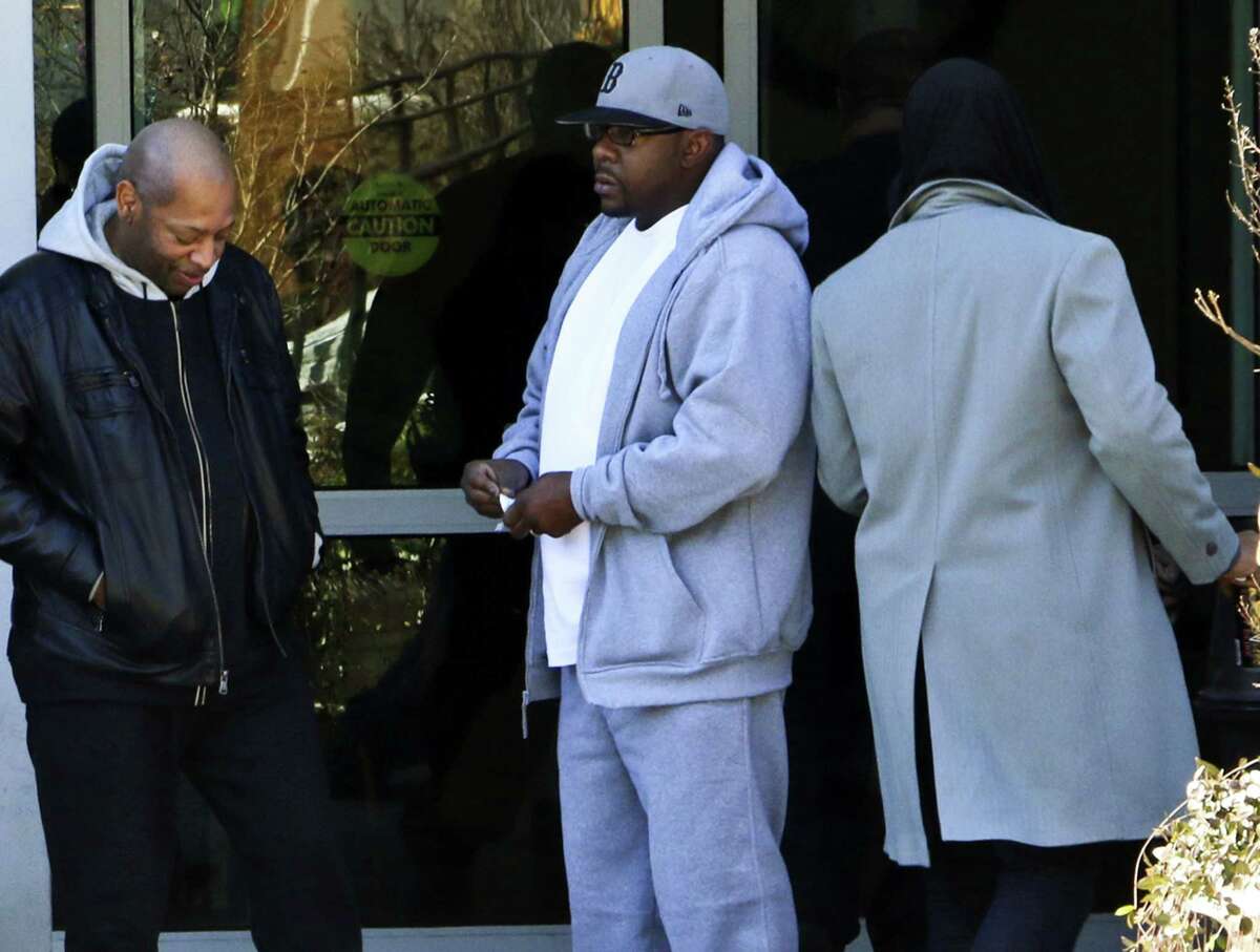 In this image made from video, entertainer Bobby Brown, center, stands outside of Emory Hospital in Atlanta where his daughter Bobbi Kristina Brown is being treated, Thursday, Feb. 5, 2015. Bobbi Kristina Brown, the only child of Bobby Brown and the late Whitney Houston, has been hospitalized since Jan. 31 after being found unresponsive in a bathtub at a suburban Atlanta home.
