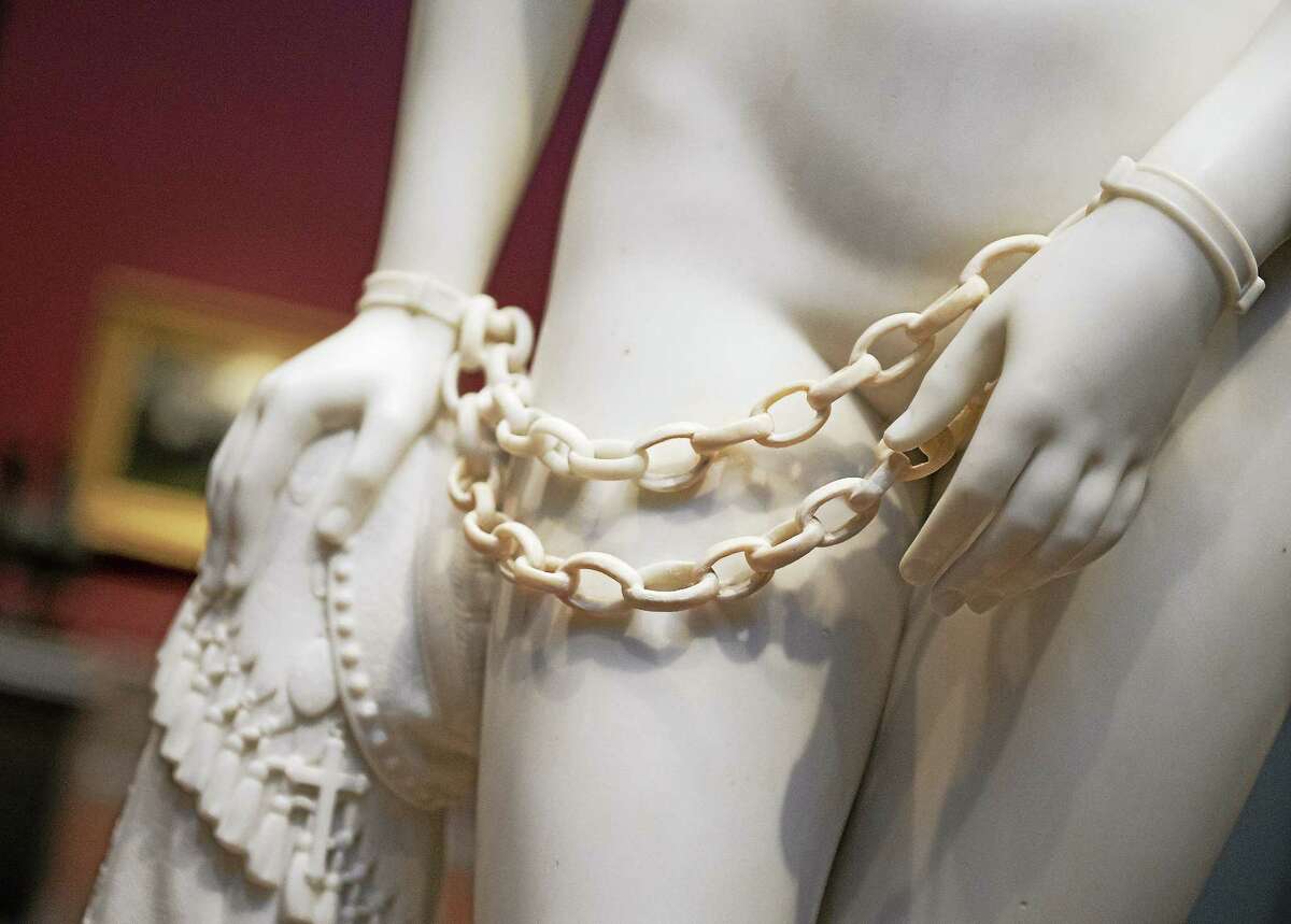 Detail of Hiram Powers marble sculpture "The Greek Slave" is displayed along with other artwork from the Corcoran Gallery of Art, Thursday, Feb. 5, 2015, at the National Gallery of Art in Washington. Thousands of prized artworks from the Corcoran, one of the nation's oldest, now shuttered art museums, have been selected for an unprecedented acquisition by the National Gallery of Art. (AP Photo/Molly Riley)