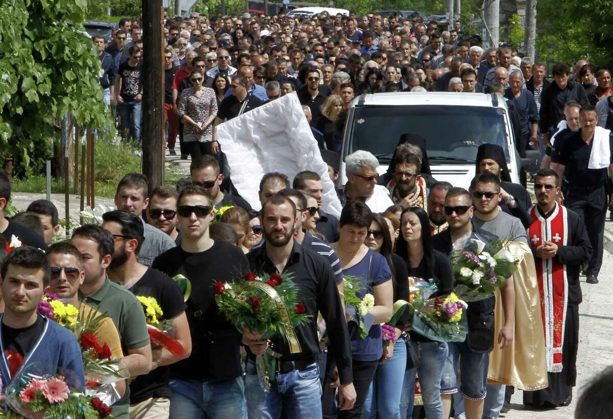 A funeral procession for Macedonian police officer Nenad Serafimovski moves through the village of Zubovci, near Gostivar, in western Macedonia, Sunday, May 10, 2015. Serafimovski is one of the eight police officers who were killed in an exchange of fire between special police forces and an armed group that started in Macedonian northern town of Kumanovo on Saturday. Macedonia's prime minister says the armed group involved in bloody battles with the police this weekend in this northern town had aimed to attack state buildings and public spaces. (AP Photo/Boris Grdanoski)