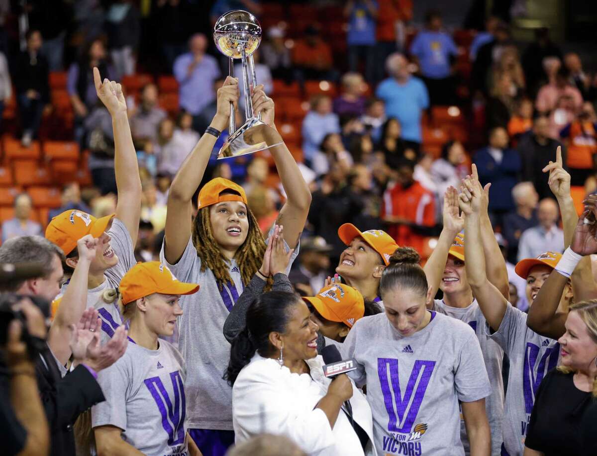 Phoenix Mercury center Brittney Griner (holding trophy) married fellow WNBA player Glory Johnson of the Tulsa Shock on Friday.