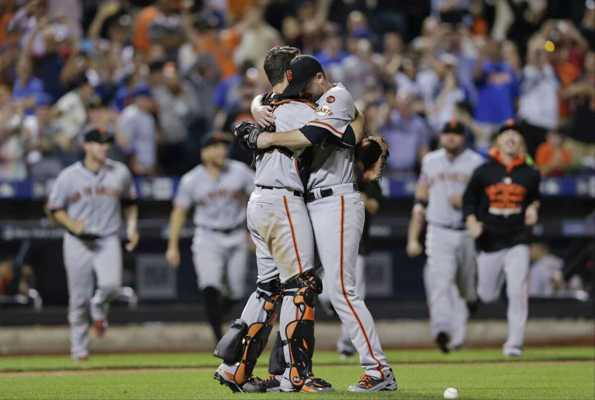 San Francisco Giants starting pitcher Chris Heston hugs catcher Buster Posey, left, after Heston’s no-hitter against the New York Mets on Tuesday. The Giants won 5-0.