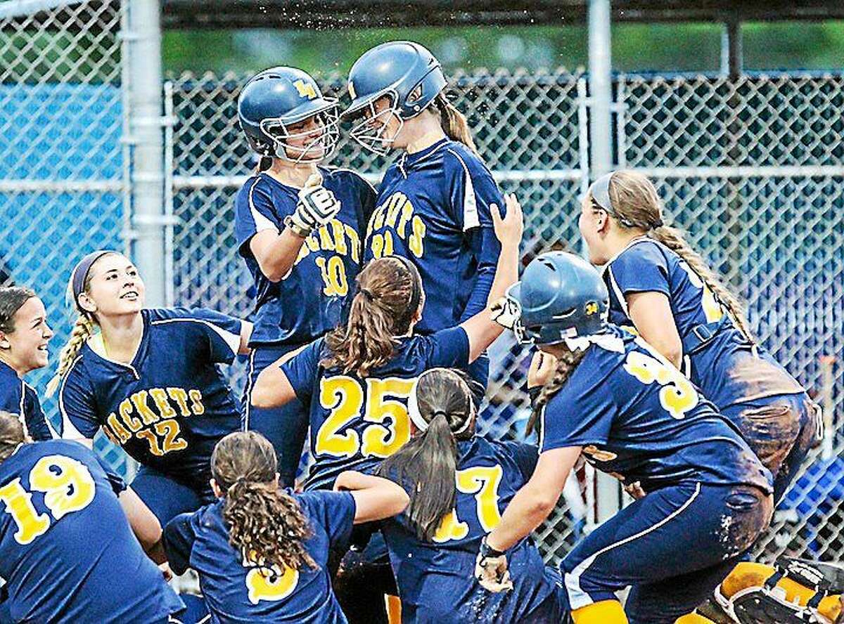 Members of the East Haven softball team celebrate the 5th inning homerun by Julia SanGiovanni (#30) during East Havenís win over Nonnewaug to gain a berth to the State Class L softball final.