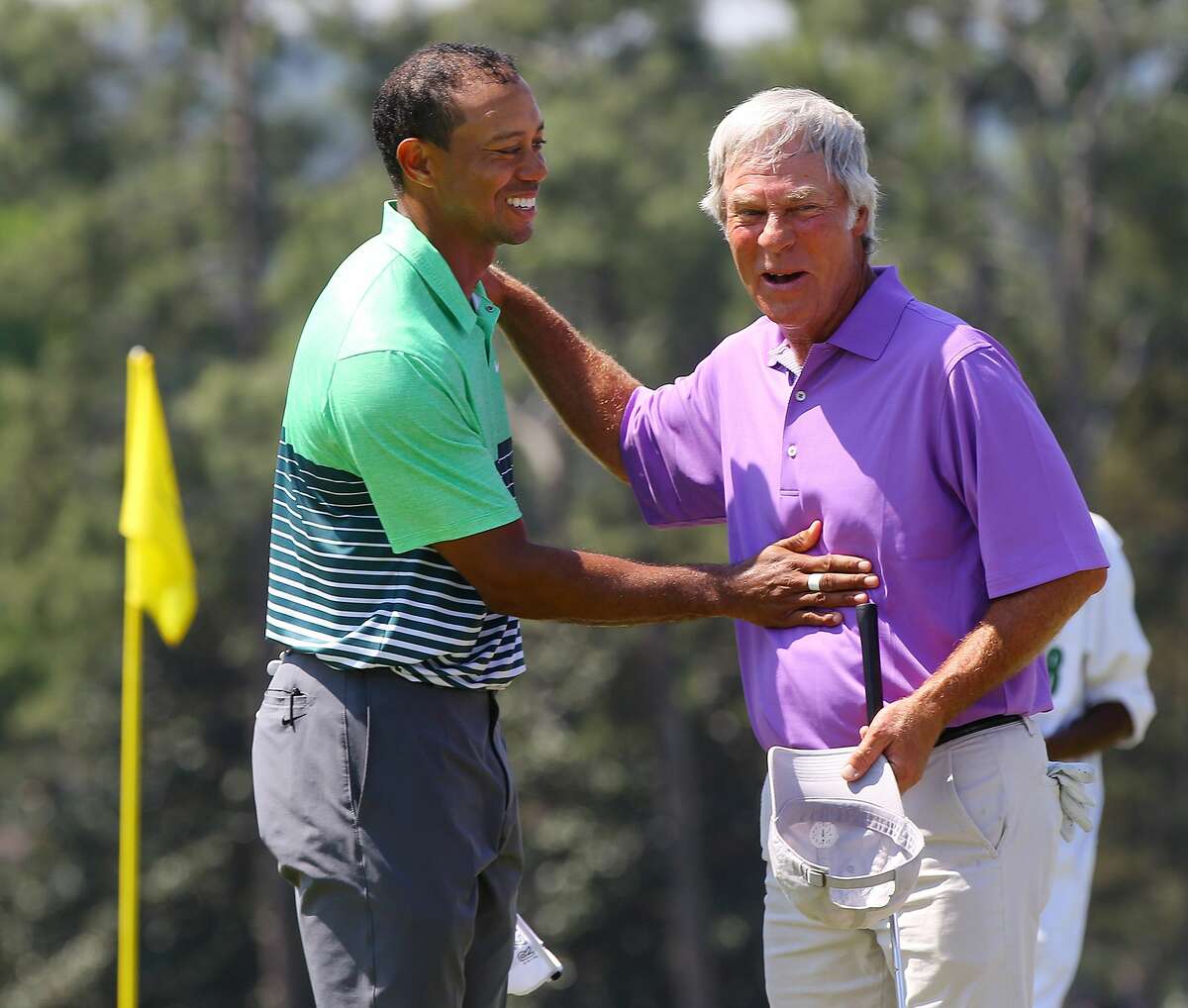 Tiger Woods, left, and Ben Crenshaw embrace on the 18th green as they finish a practice round for the Masters on Wednesday in Augusta, Ga.