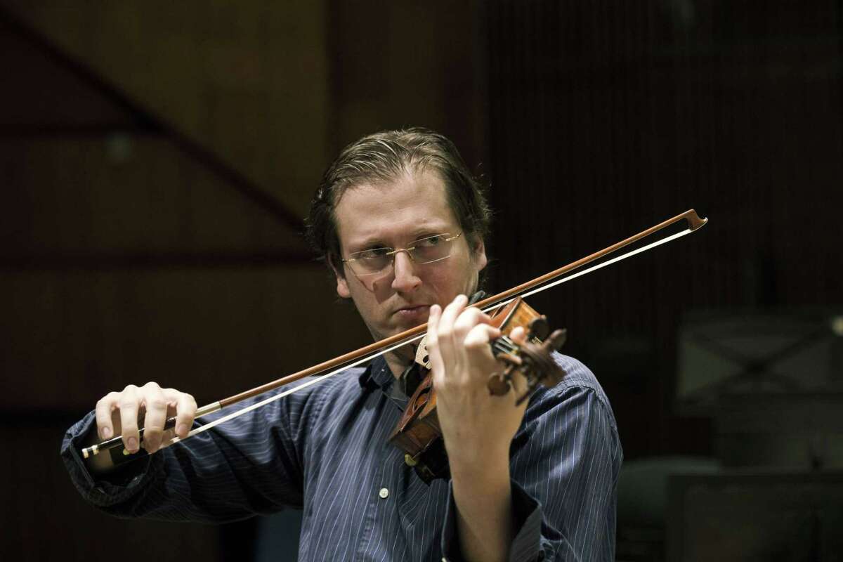 David Radzynski an American-Israeli concertmaster of the Israel Philharmonic Orchestra, plays during a rehearsal in Tel Aviv concert hall.