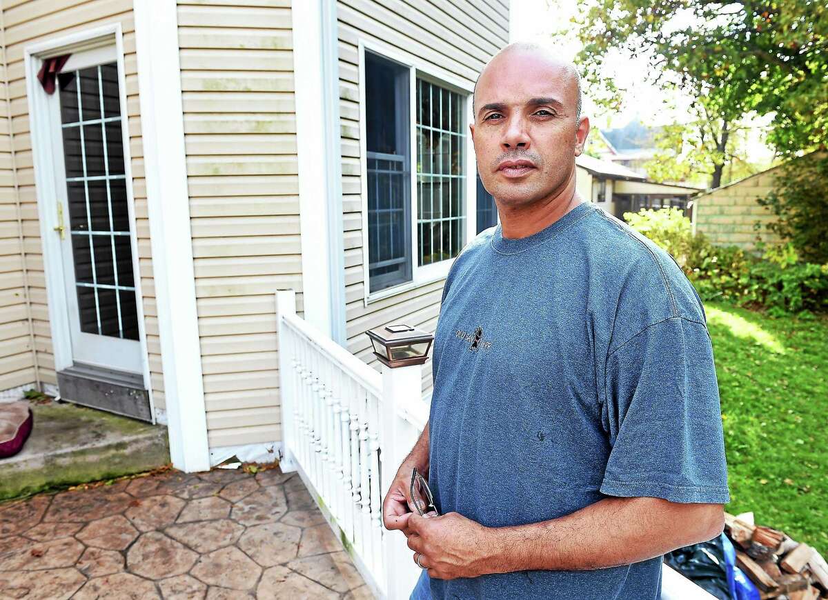 Angelo Reyes Jr. on the rear patio of the house he built in Fair Haven Heights.