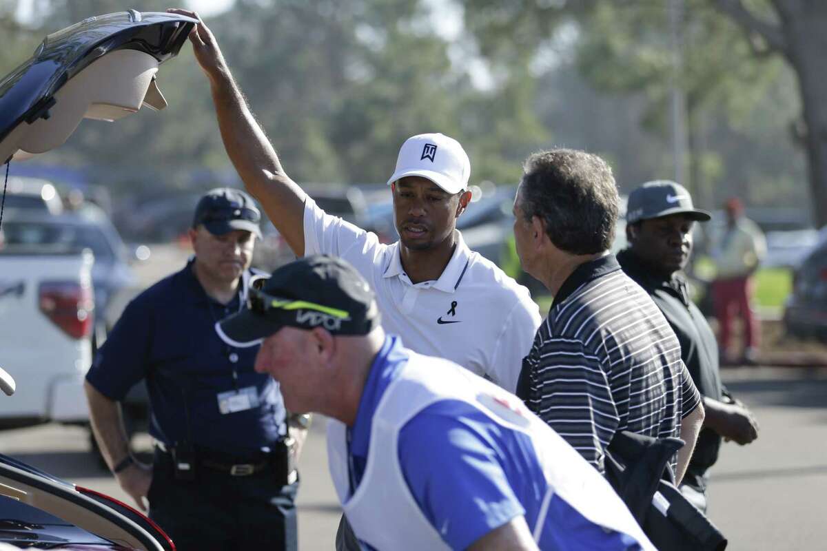 Tiger Woods loads his car after withdrawing in the first round of the Farmers Insurance Open Thursday in San Diego.