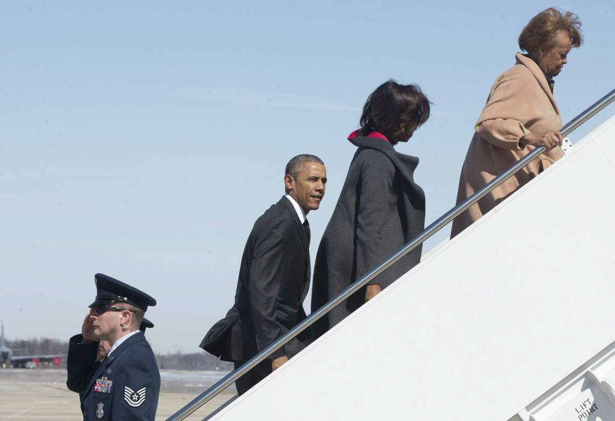 President Barack Obama, from left, first lady Michelle Obama, and Marian Robinson board Air Force One en route to the commemoration of the 50th anniversary of ìBloody Sunday," a landmark event of the civil rights movement, from Andrews Air Force Base, Md., Saturday, March 7, 2015. (AP Photo/Jacquelyn Martin)