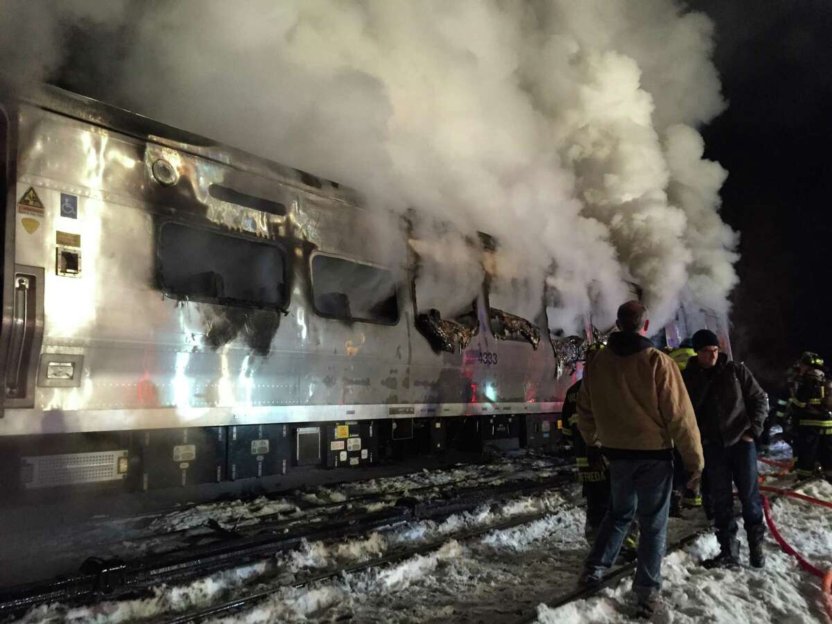 A Metro-North Railroad passenger train smolders after hitting a vehicle in Valhalla, N.Y., Tuesday, Feb. 3, 2015.