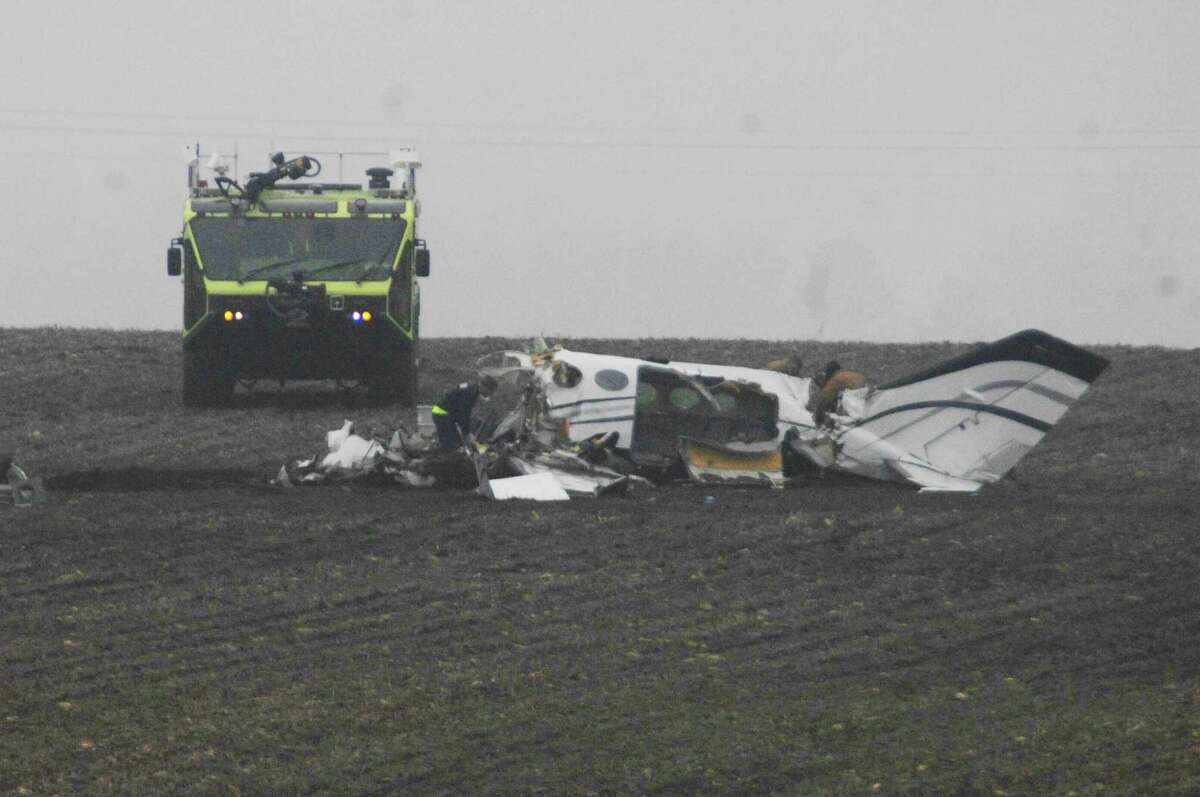 Investigators work at the site of a small plane crash Tuesday near Bloomington, Ill.