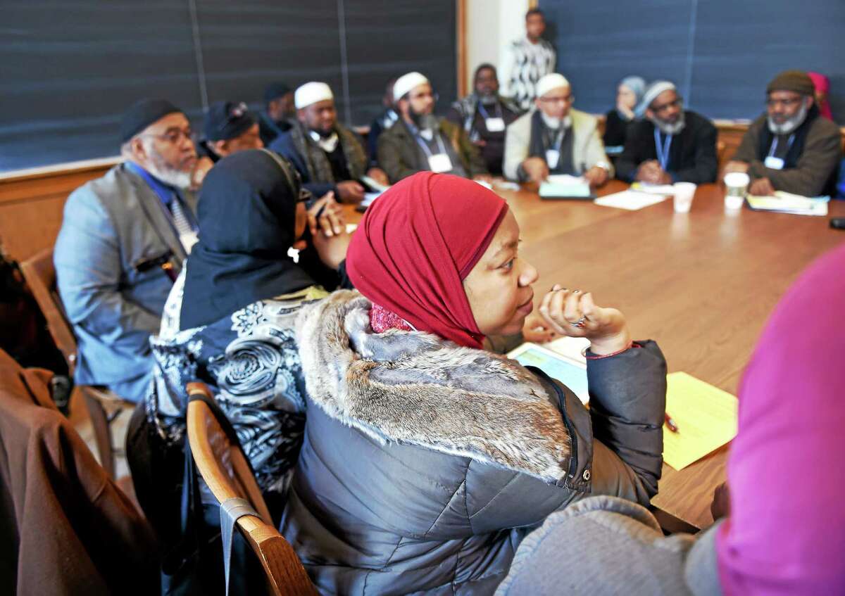 (Arnold Gold-New Haven Register) Maryam Sharrieff (center) of Massachusetts and others listen to Altaf Husain (not in photo), Vice President of the Islamic Society of North America, speak about The Bilal Initiative: Understanding and Dealing with Prejudice in the Muslim American Community during the 5th Annual National Shura and In-service Training for Chaplains and Imams and Other Service Providers to the Muslim Community at Yale University in New Haven on 3/7/2015