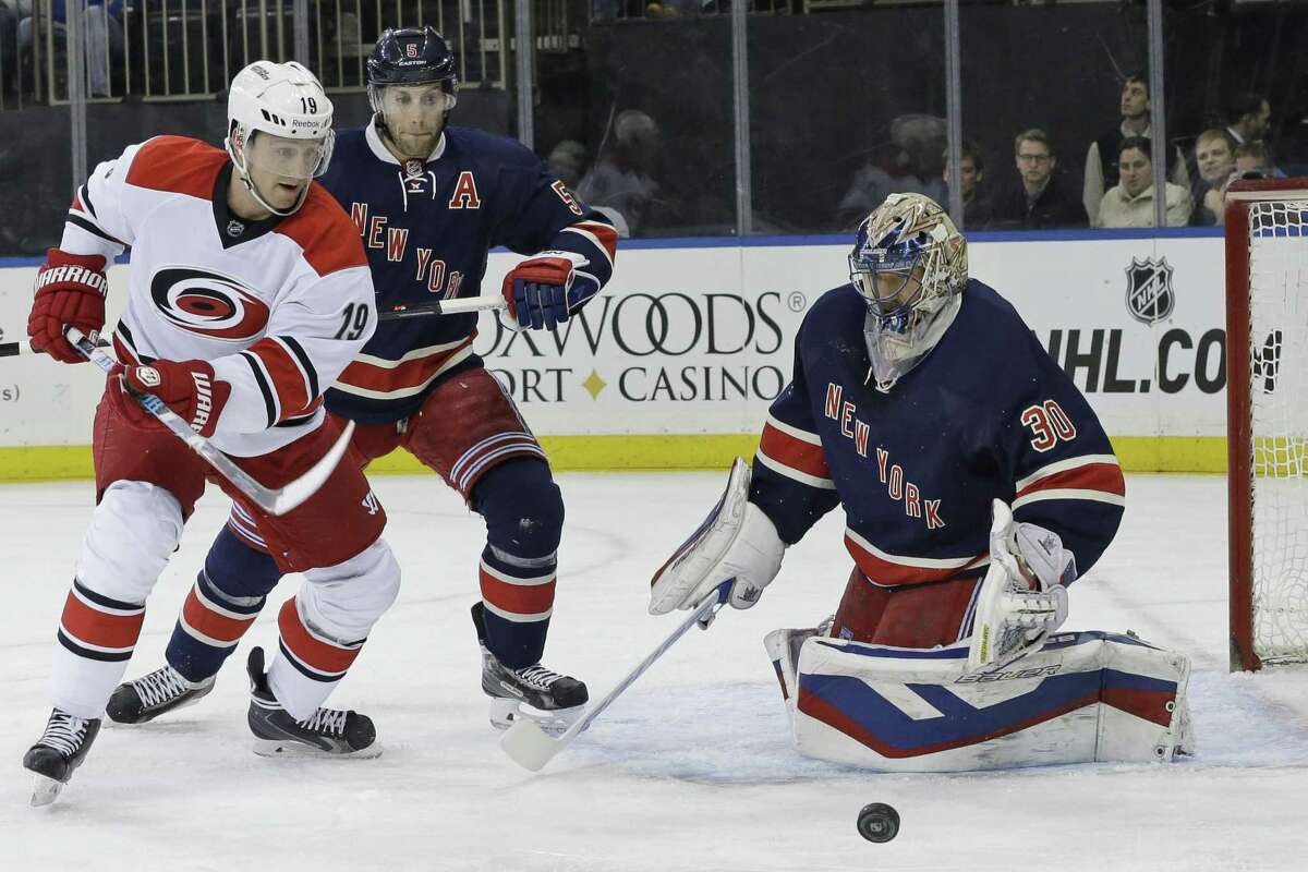New York Rangers's goalie Henrik Linqvist stops the puck hit by