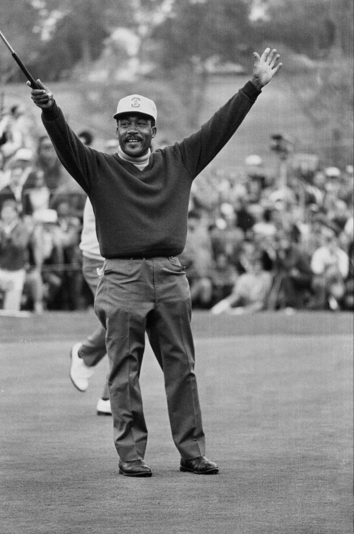 In this Jan. 13, 1969 file photo, Charlie Sifford throws up his arms after he dropped a short par putt on the 18th green to tie Harold Henning at the end of 72 holes in the Los Angeles Open.