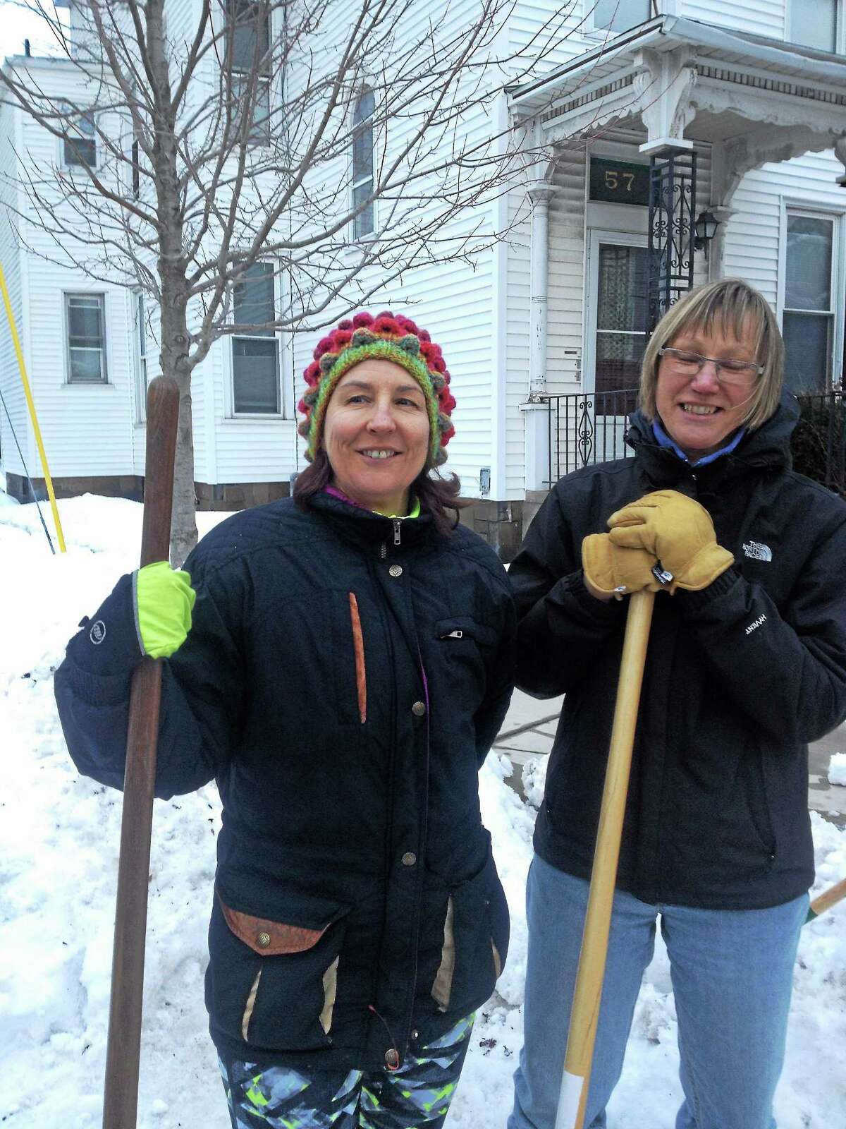 Lisa Siedlarz and Christiane Cunnar take a break from shoveling on Pearl Street. Register photo - Mary O’Leary