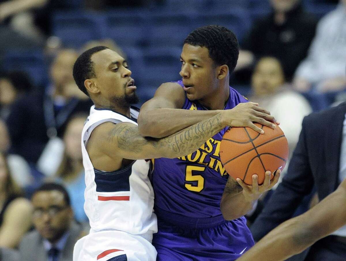 UConn’s Ryan Boatright (11) guards East Carolina’s Lance Tejada (5) during the first half Wednesday. UConn won 65-52.