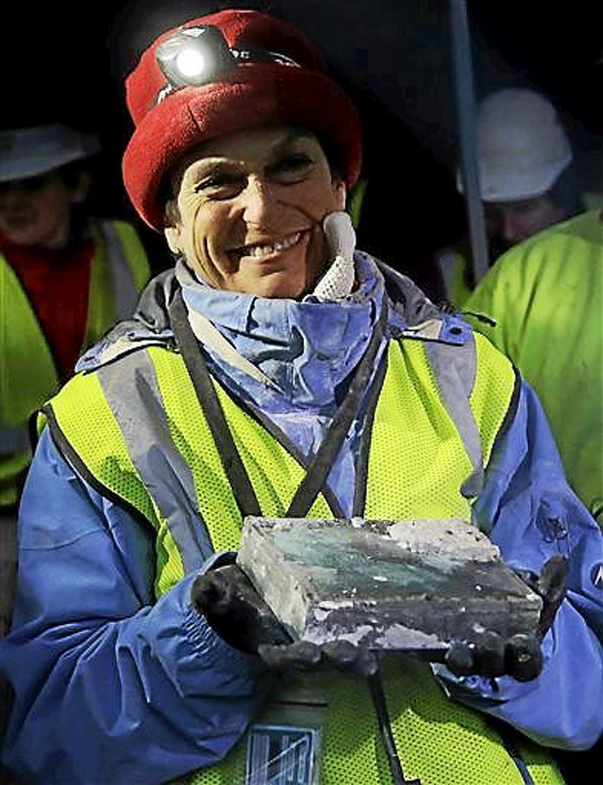 Pamela Hatchfield, a conservator at the Boston’s Museum of Fine Arts, holds a time capsule she removed Dec. 11 from the cornerstone of the Statehouse in Boston.