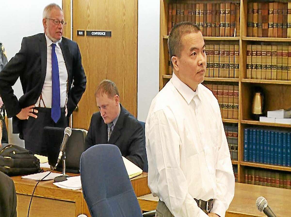 (Pool photo - WTNH) Dr. Lishan Wang, at front, during a pre-trial hearing at Superior Court in New Haven. Chief Public Defender Thomas Ullmann, standing at rear is seeking to end Wang’s self-representation on a murder charge,