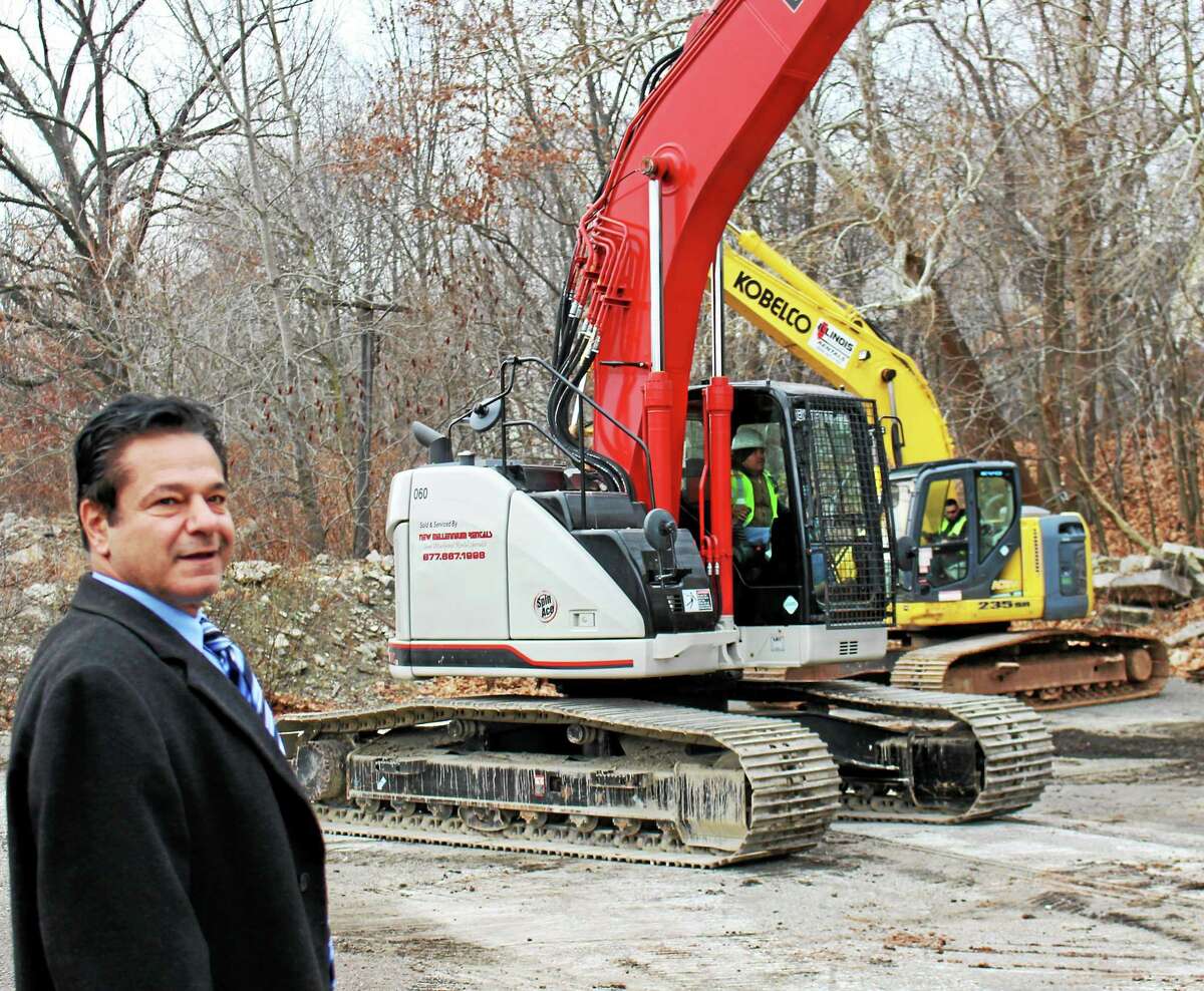 Ansonia Mayor David Cassetti watches the first phase of the Ansonia Copper & Brass property being demolished.
