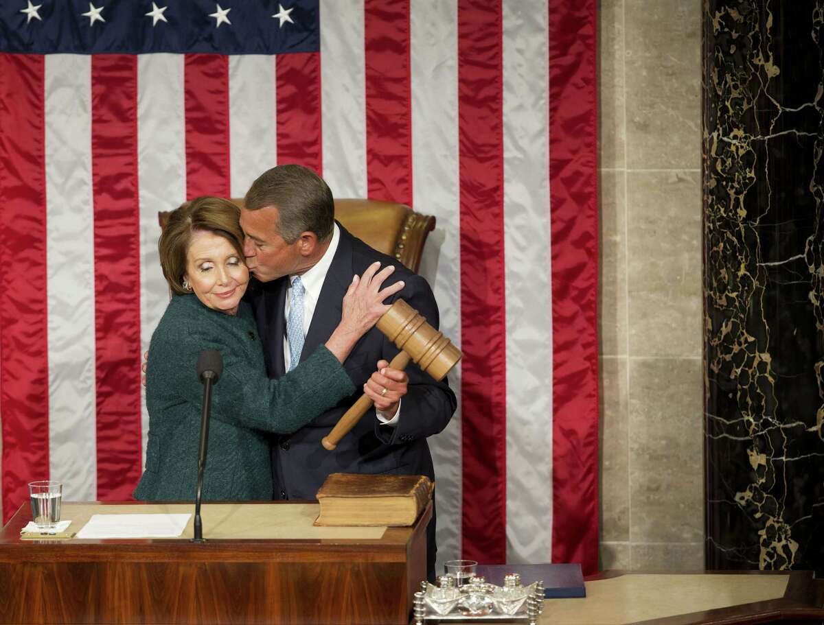 House Speaker John Boehner of Ohio kisses House Minority Leader Rep. Nancy Pelosi of Calif. after being re-elected to a third term during the opening session of the 114th Congress, as Republicans assume full control for the first time in eight years, Tuesday, Jan. 6, 2015, on Capitol Hill in Washington.