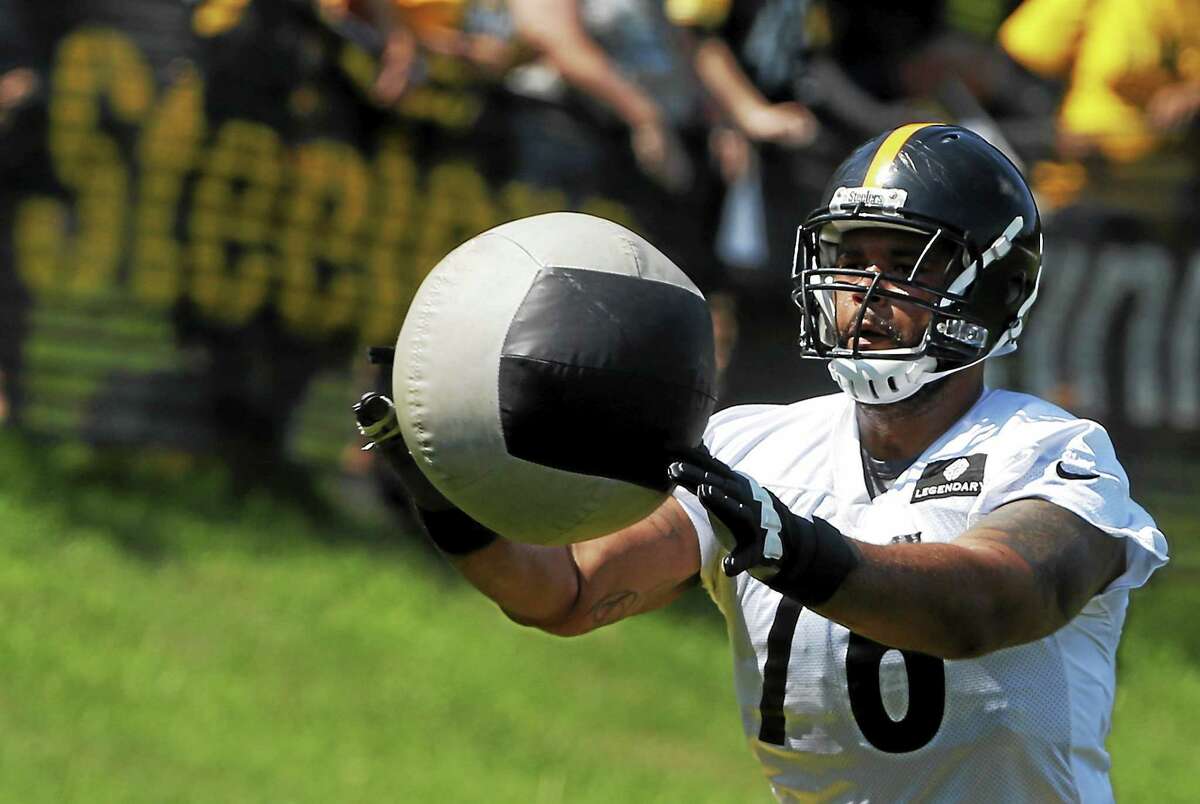 Pittsburgh Steelers tackle Mike Adams (76) tosses a medicine ball during an NFL football training camp practice in Latrobe, Pa. on July 26, 2014.