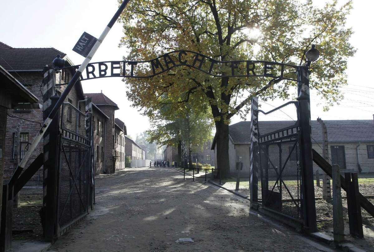 FILE - In this Oct. 19, 2012 file photo the entrance with the inscription "Arbeit Macht Frei" (Work Sets You Free) the former German Nazi death camp of Auschwitz is pictured in Oswiecim, Poland. A German court says a 93-year-old man will go on trial in April on allegations he was accessory to 300,000 murders as an SS guard at the Nazisí Auschwitz death camp. The Lueneburg state court said Monday Feb. 2, 2015 Oskar Groeningís trial would open April 21. Groening has openly talked about his time as a guard and says he witnessed atrocities but didn't commit any himself. Heís one of some 30 former Auschwitz guards who federal investigators in 2013 recommended that state prosecutors pursue charges against. (AP Photo/Czarek Sokolowski, File)