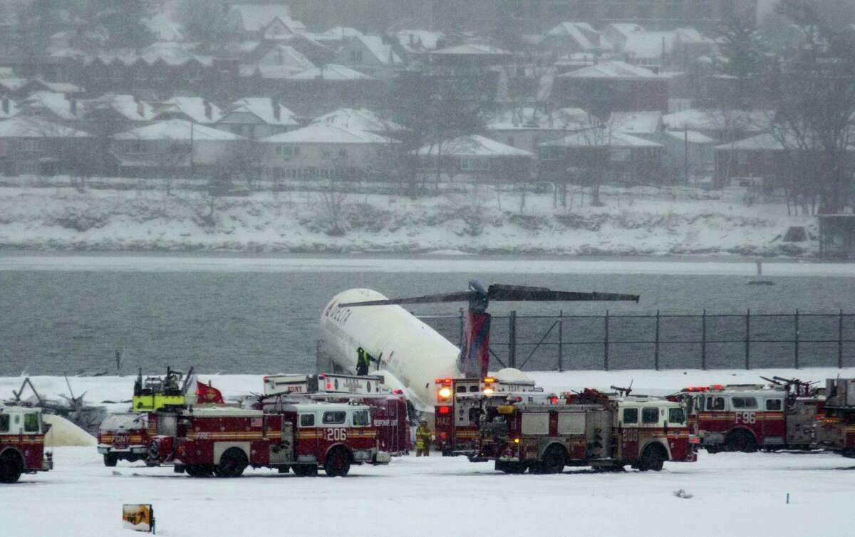 A Delta plane rests on a berm near the water at LaGuardia Airport in New York, Thursday, March, 2015. Delta Flight 1086, carrying 125 passengers and five crew members, veered off the runway at around 11:10 a.m., authorities said. Six people suffered non-life-threatening injuries, said Joe Pentangelo, a spokesman for the Port Authority of New York and New Jersey, which runs the airport.