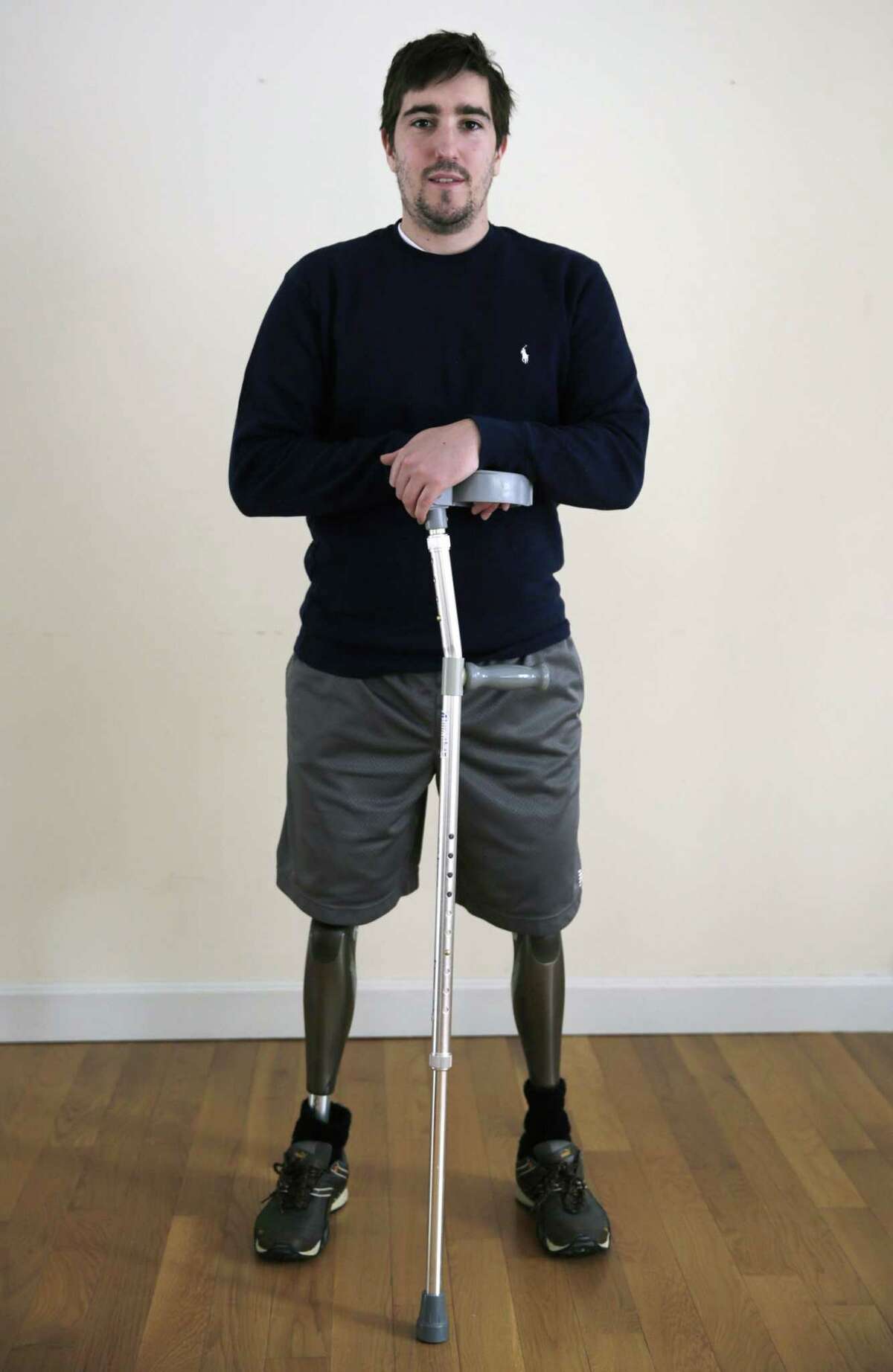 FILE - In this March 14, 2014 file photo, Jeff Bauman stands in his home in Carlisle, Mass. Bauman, who lost both of his legs in the Boston Marathon bombings, testified Thursday, March 5, 2015, in the federal death penalty trial of Dzhokhar Tsarnaev in Boston. Tsarnaev is charged with conspiring with his brother to place twin bombs near the finish line of the race, killing three and injuring 260 people. (AP Photo/Charles Krupa, File)