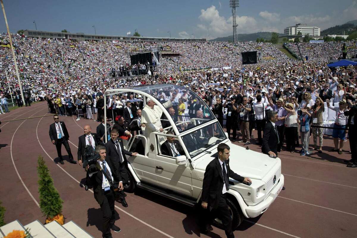 Pope Francis arrives to celebrate a Mass at the Kosevo stadium, in Sarajevo, Bosnia-Herzegovina, Saturday, June 6, 2015. Pope Francis urged Bosnia's Muslims, Orthodox and Catholics to put the "deep wounds" of their past behind them and work together for a peaceful future as he arrived in Sarajevo on Saturday for a one-day visit to encourage reconciliation following the devastating three-way war of the 1990s. (AP Photo/Andrew Medichini)