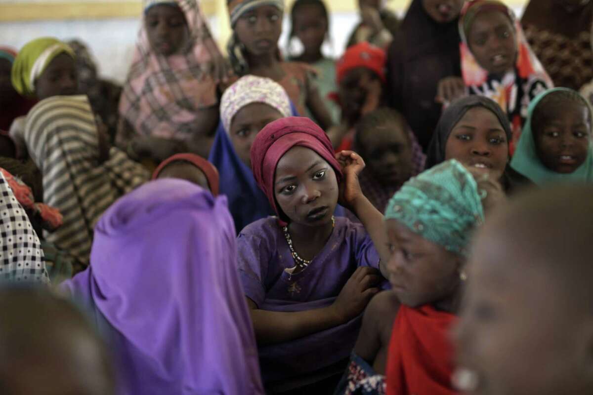 Nigerian girls who fled Boko Haram to Chad gather in a school set up by UNICEF at the Baga Solo refugee camp in Chad, Wednesday March 4, 2015. The camp, jointly run by the Chadian government and the United Nations refugee agency UNHCR, opened in January 2015 and hosts over 6,000 refugees. Many families have been divided and Chadian authorities believe more than 2,000 people remain trapped on islands in Lake Chad, which borders Chad, Nigeria and parts of Cameroon and Niger. (AP Photo/Jerome Delay)