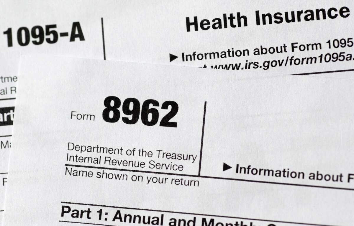 This Aug. 21, 2014 file photo shows health care tax forms 8962 and 1095-A.