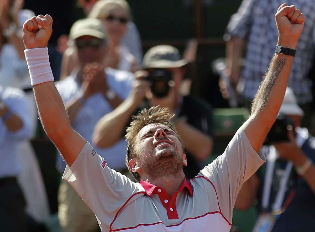 Stan Wawrinka clenches his fists after defeating Jo-Wilfried Tsonga during their semifinal match at the French Open Friday at Roland Garros Stadium in Paris.