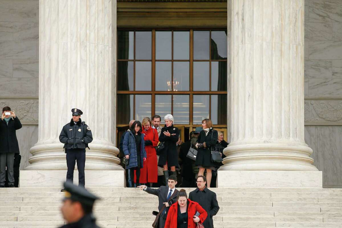 Former Health and Human Services Secretary Kathleen Sebelius, center, exits the Supreme Court in Washington, Wednesday, March 4, 2015. The Supreme Court heard arguments in King v. Burwell, a major test of President Barack Obama's health overhaul which, if successful, could halt health care premium subsidies in all the states where the federal government runs the insurance marketplaces. (AP Photo/Andrew Harnik)