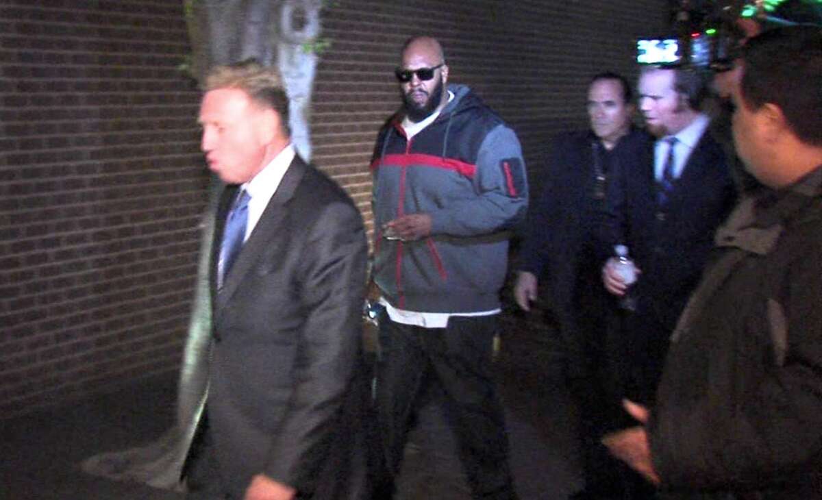 This image from video shows Death Row Records founder Marion “Suge” Knight, right, walking into the Los Angeles County Sheriffs department early Friday morning Jan. 30, 2015 in connection with a hit-and-run incident that left one man dead and another injured.