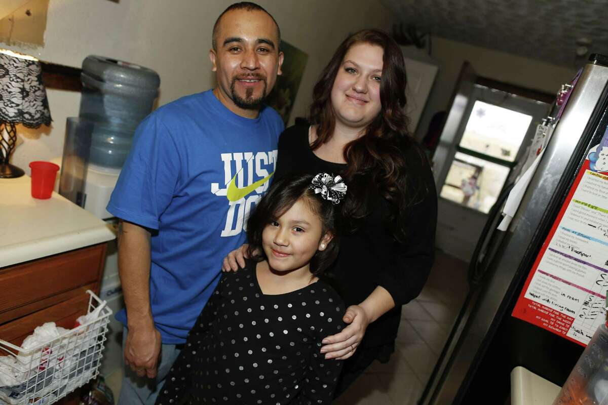 Maximiano Vazquez-Guevara, left, his wife Ashley Bowen, and their 6-year-old daughter, Nevaeh Vazquez, pose for a photo in their home on Jan. 31, 2015, in the northeast Denver suburb of Commerce City, Colo.
