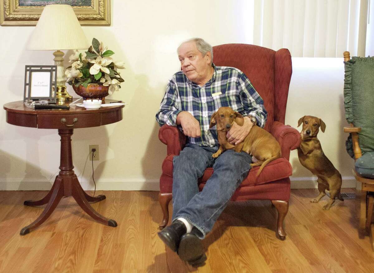 Larry Wilkins retells the story of how his dogs, Bonnie and Pete (left), alerted him to a noise on his front porch, where he would meet the seven-year-old sole survivor of a airplane crash. "I come to the door and there's a little girl, 7 years old, bloody nose, bloody arms, bloody legs, one sock, no shoes, crying," Wilkins, 71, told The Associated Press on Saturday. "She told me that her mom and dad were dead, and she had been in a plane crash, and the plane was upside down." (AP Photo/The Paducah Sun, John Paul Henry)