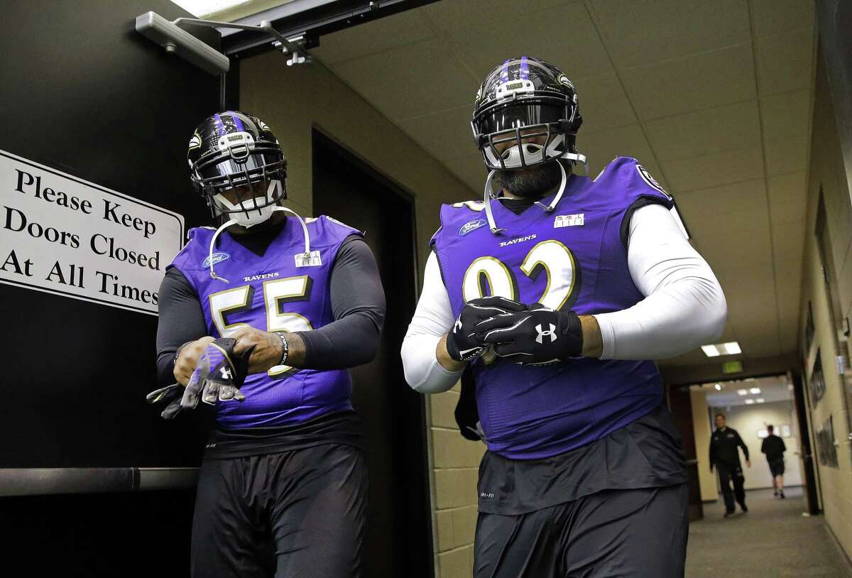 Baltimore Ravens linebacker Terrell Suggs, left, and defensive end Haloti Ngata walk to practice on Tuesday in Owings Mills, Md.